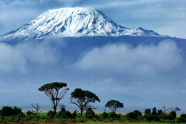Climbers reaching Mount Kilimanjaro summit at sunrise, the Roof of Africa where Resilience Expeditions began
