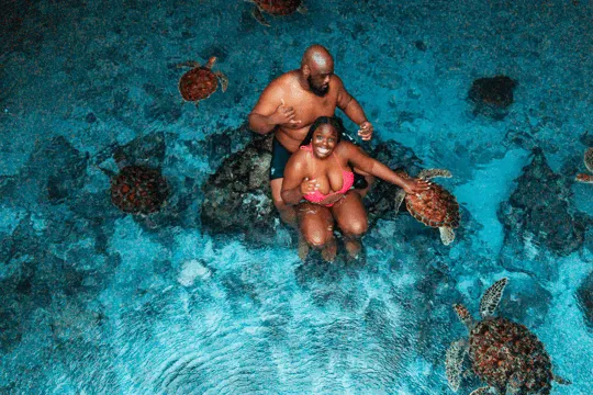 Zanzibar turquoise waters and white sand beach with dhow